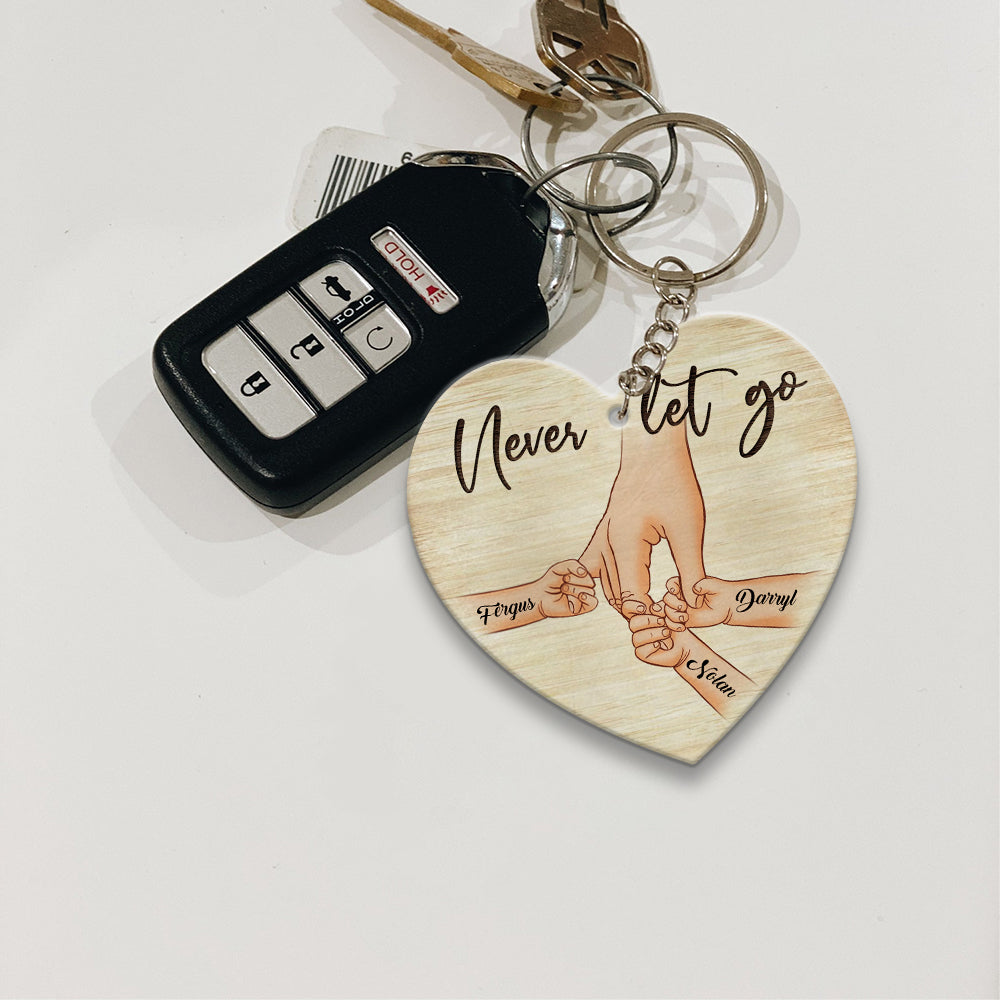 Personalized A Father Holds His Kid's Hand Never Let Go Heart Wooden Keychain