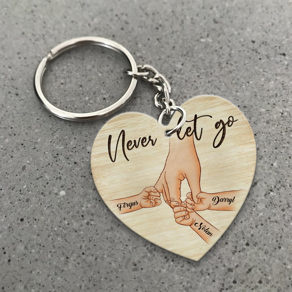Personalized A Father Holds His Kid's Hand Never Let Go Heart Wooden Keychain