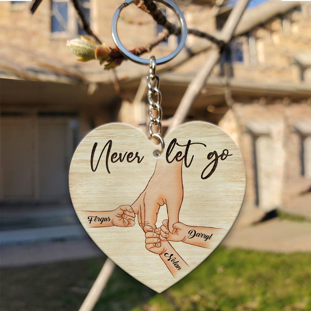 Personalized A Father Holds His Kid's Hand Never Let Go Heart Wooden Keychain