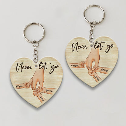 Personalized A Father Holds His Kid's Hand Never Let Go Heart Wooden Keychain