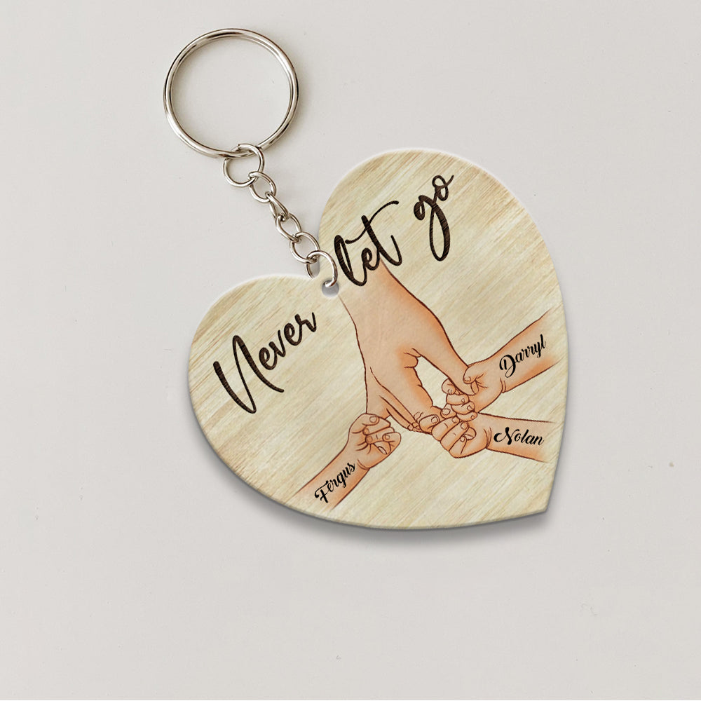 Personalized A Father Holds His Kid's Hand Never Let Go Heart Wooden Keychain